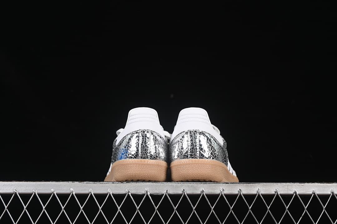 Rear view of both sneakers showing reflective heel panels and gum-colored soles
