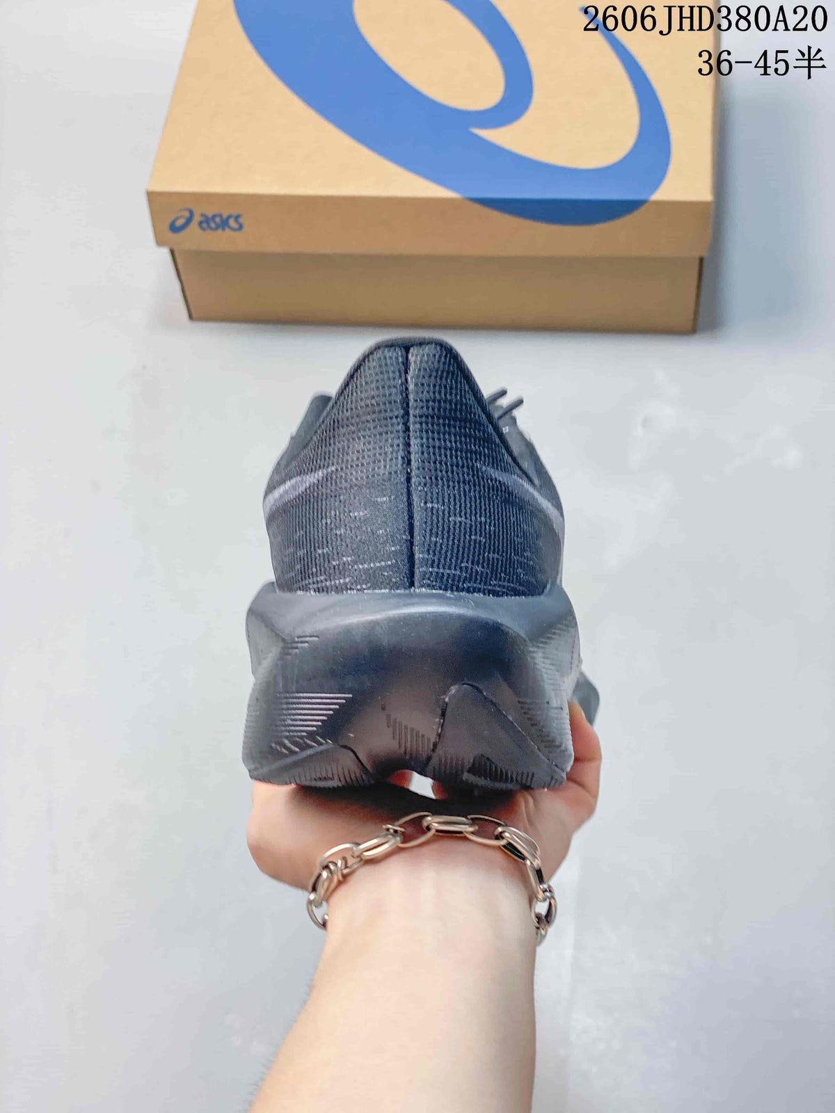 Rear view of the dark charcoal running shoe with sculpted heel sole