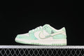 Side view of mint green and off-white Nike SB Dunk Low sneakers with Labubu-themed details