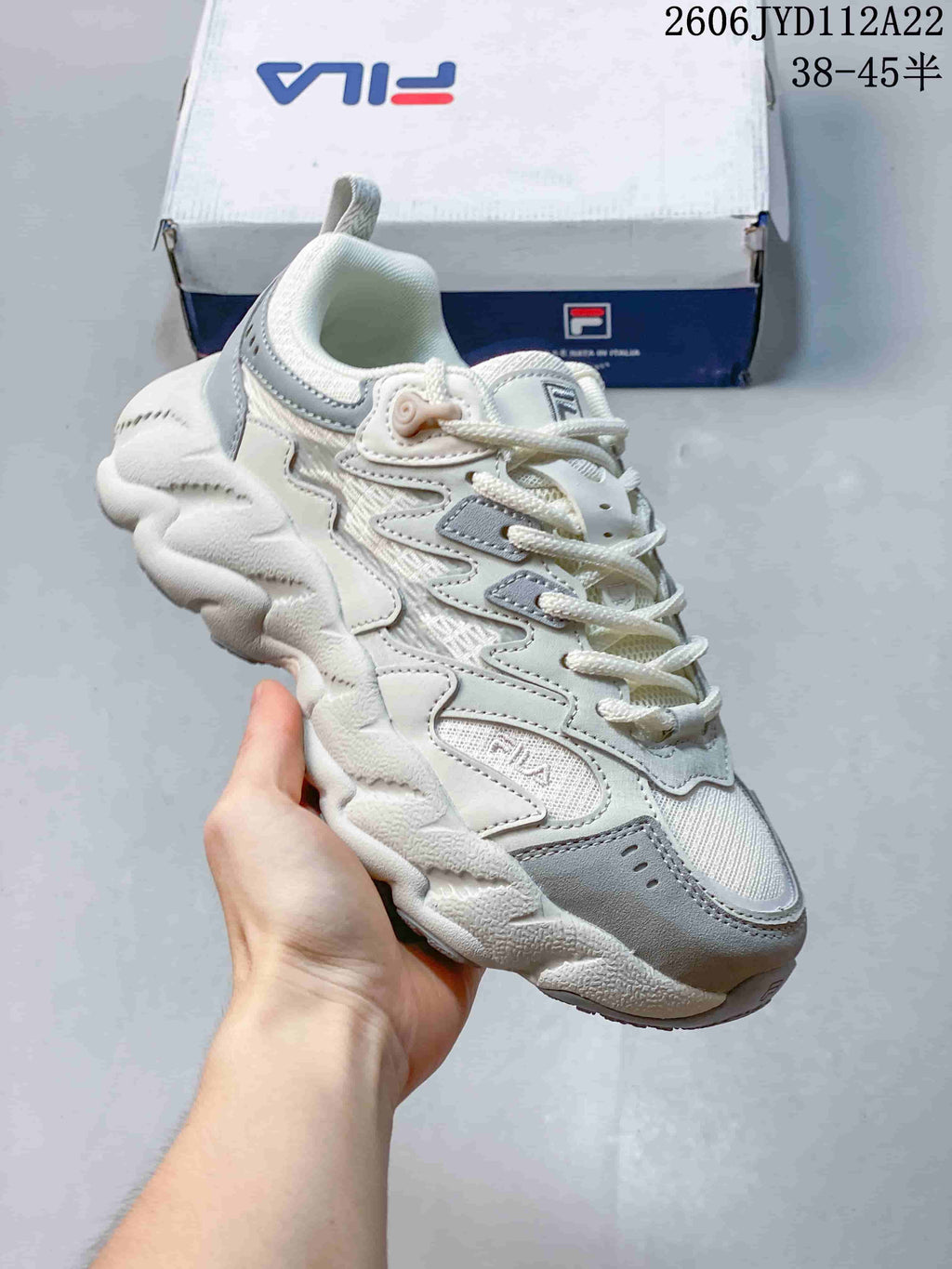 Angled view of the white and gray FILA FUSION Arceus sneaker