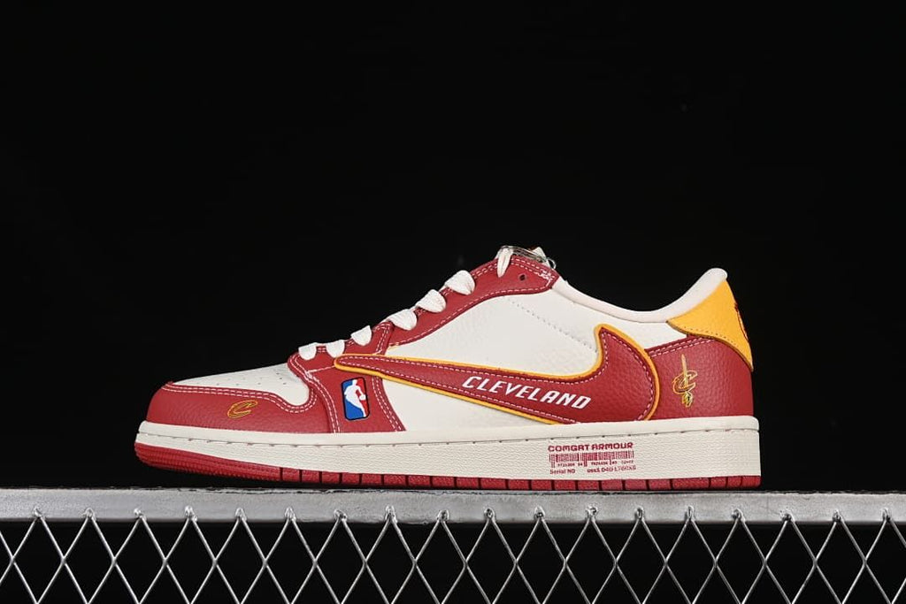 Side view of a white and red low-top sneaker with yellow accents and Cleveland-themed graphics