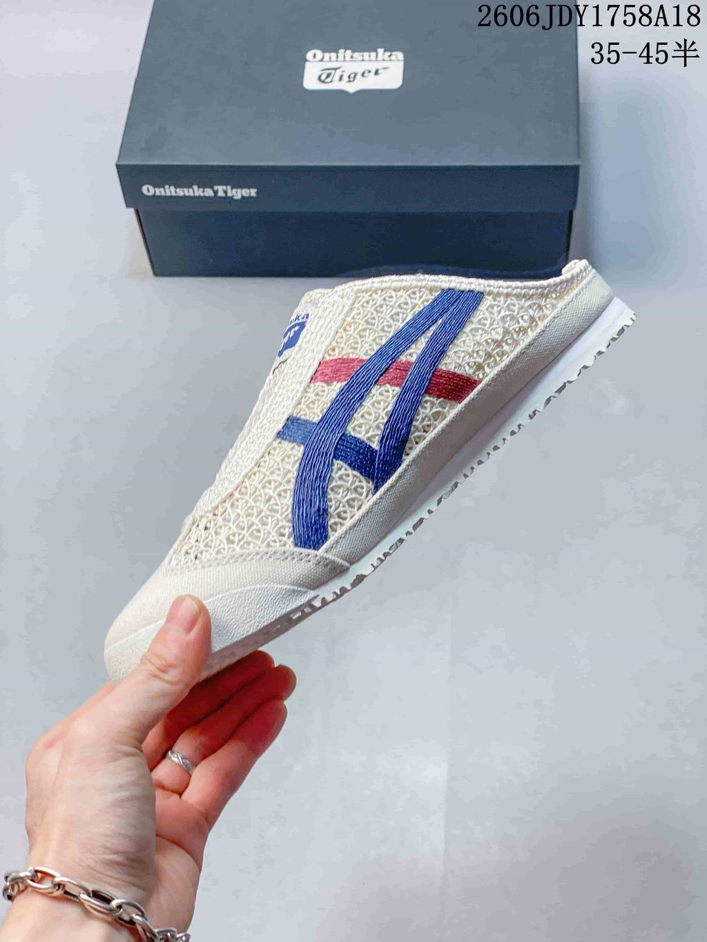 Side view of an ivory Onitsuka Tiger Mexico 66 Sabot with blue and red stripes