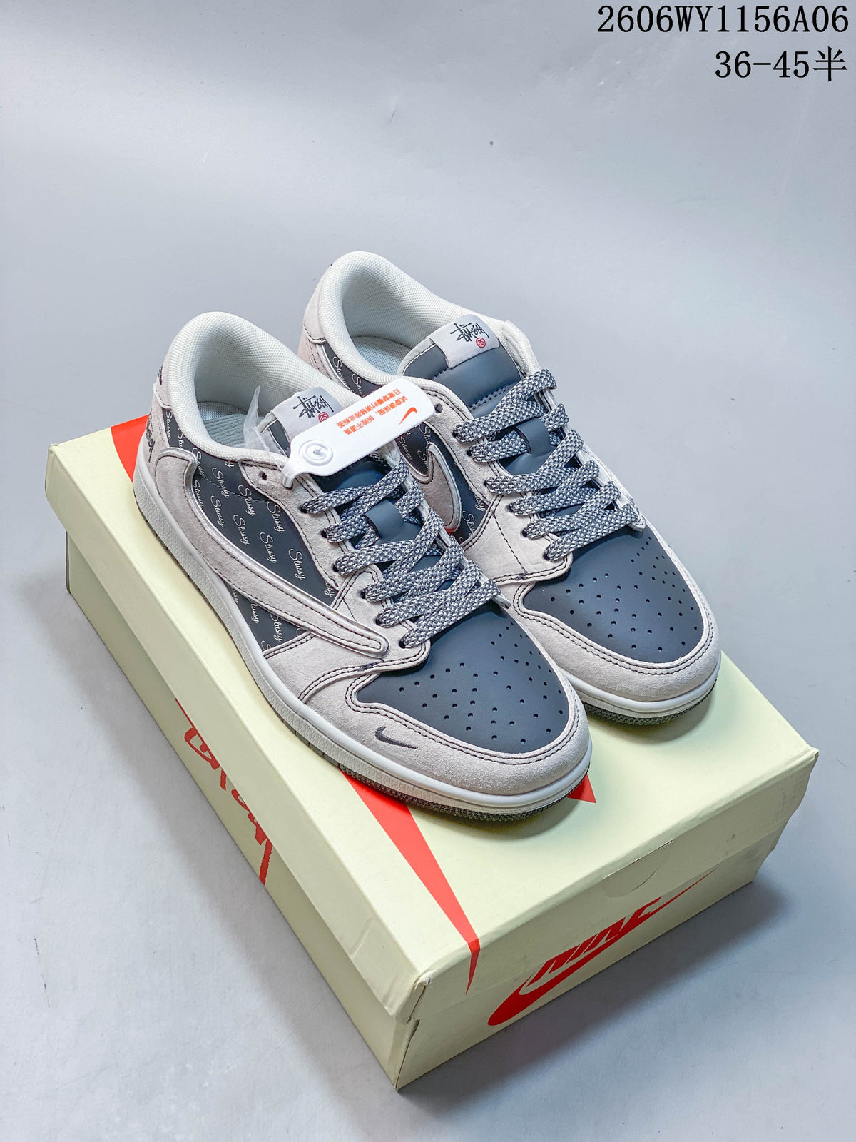 Pair of gray and dark blue low-top sneakers with patterned side panels, displayed on a shoe box