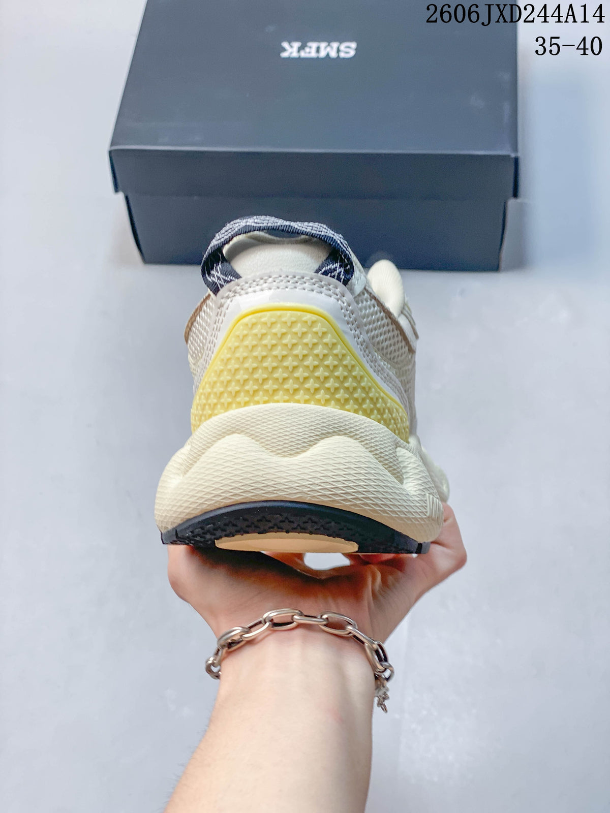 Rear view of the sneaker with a pale yellow heel detail and chunky ivory-toned sole.