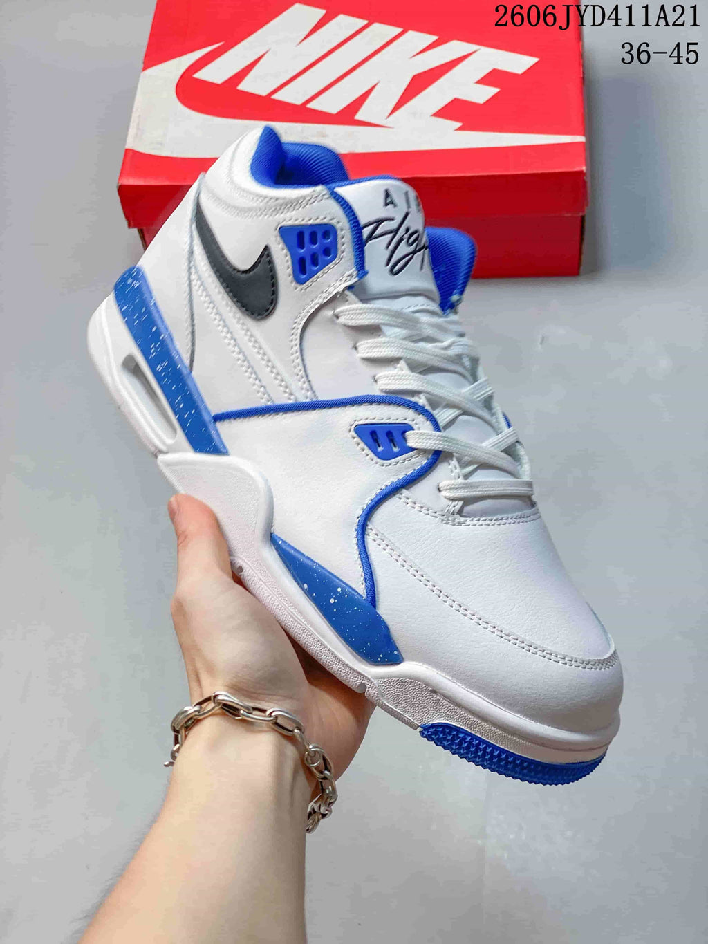 Angled side view of the white and blue Nike Flight Legacy shoe
