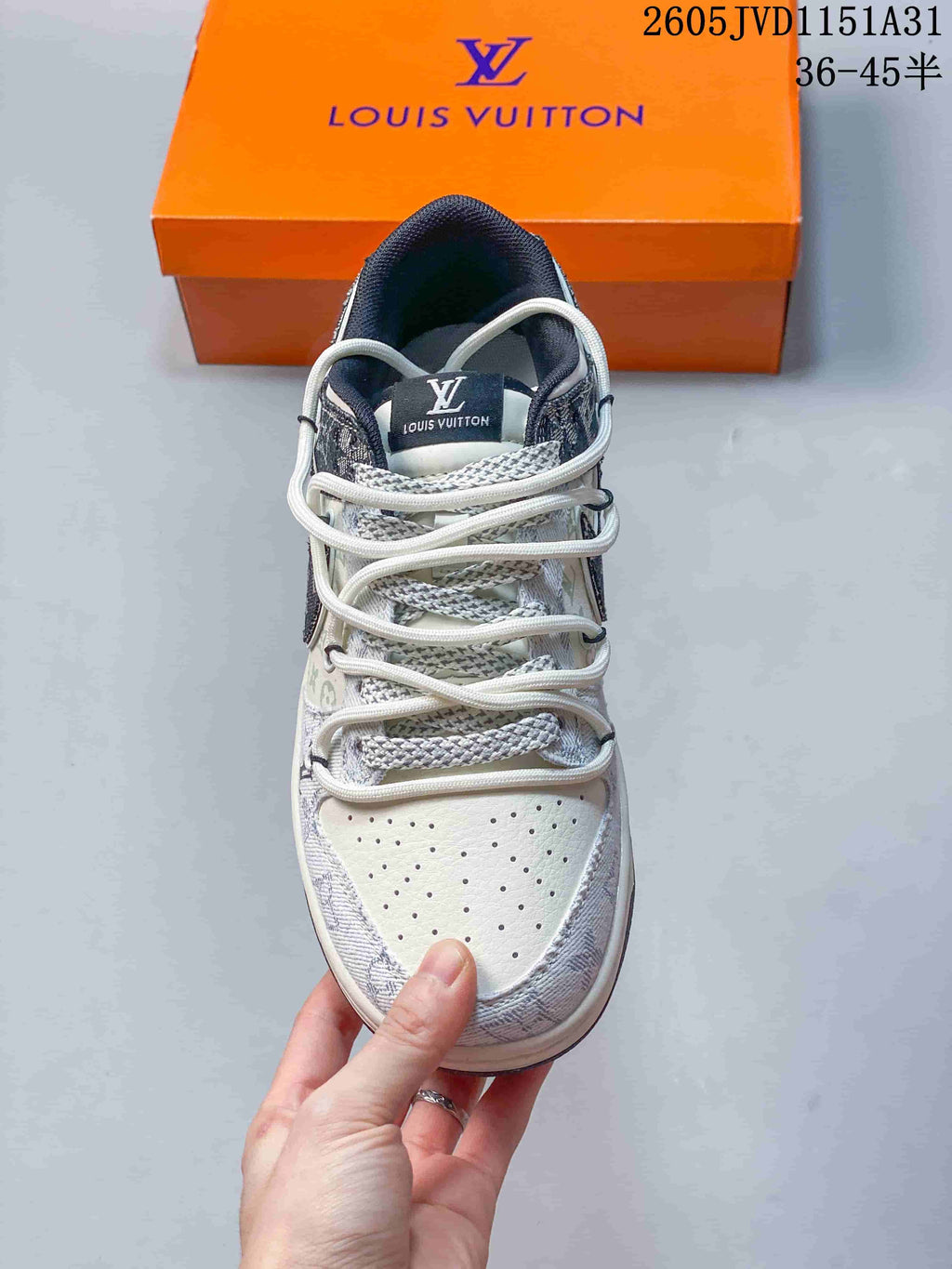 Top view of a sneaker showing perforated toe and layered laces