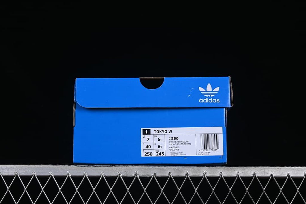 Blue adidas shoe box label identifying Tokyo W and model JI3300, with sample size information