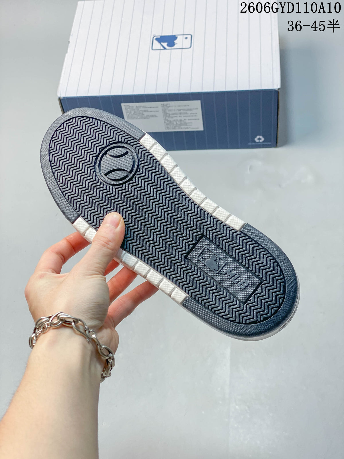 Close-up of the sneaker outsole showing a dark patterned tread