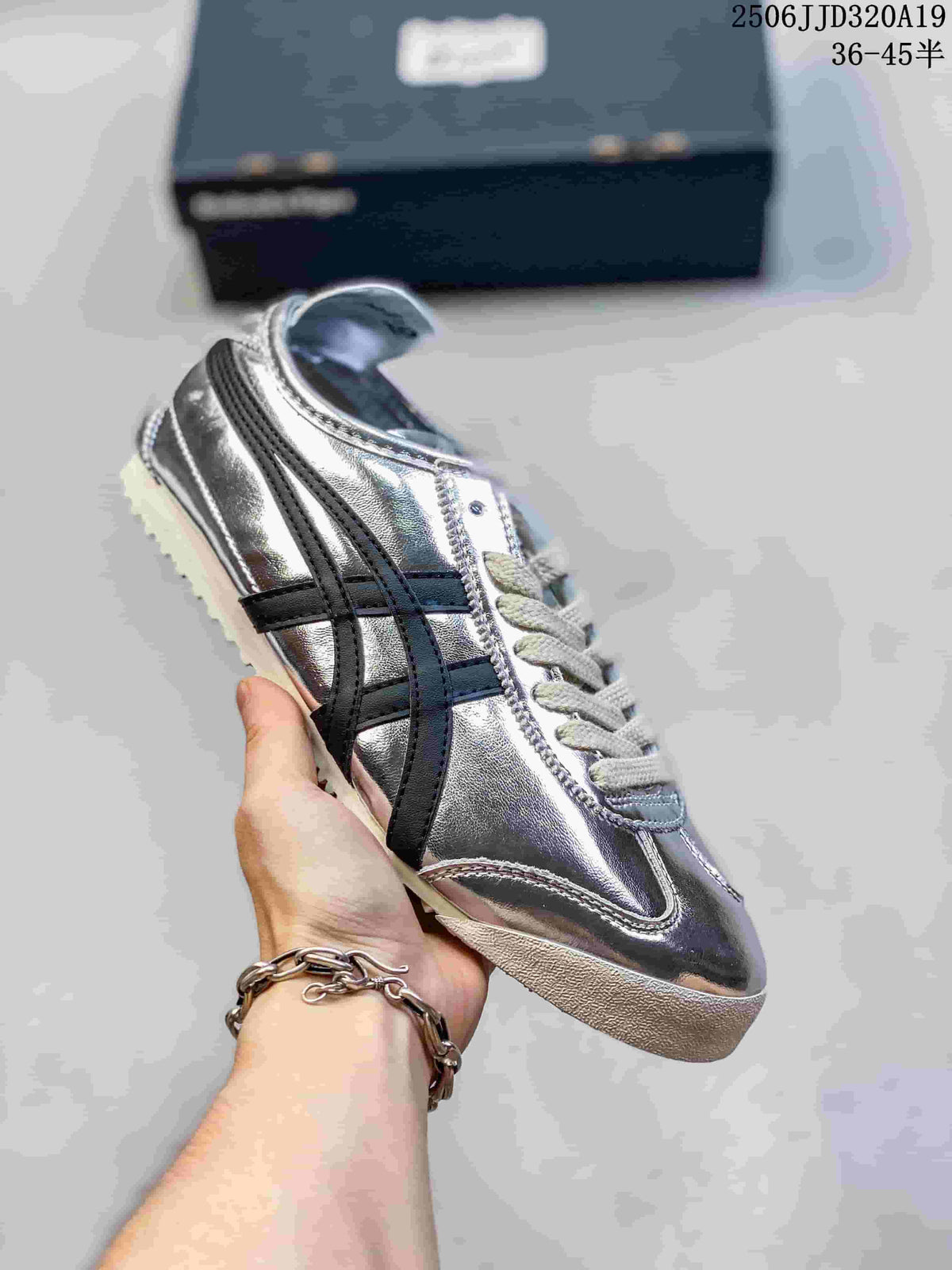 Metallic silver low-top sneaker with black side stripes and a light outsole