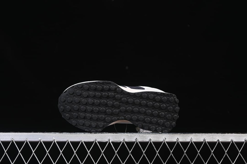 Underside view showing the dark outsole with circular tread pattern.