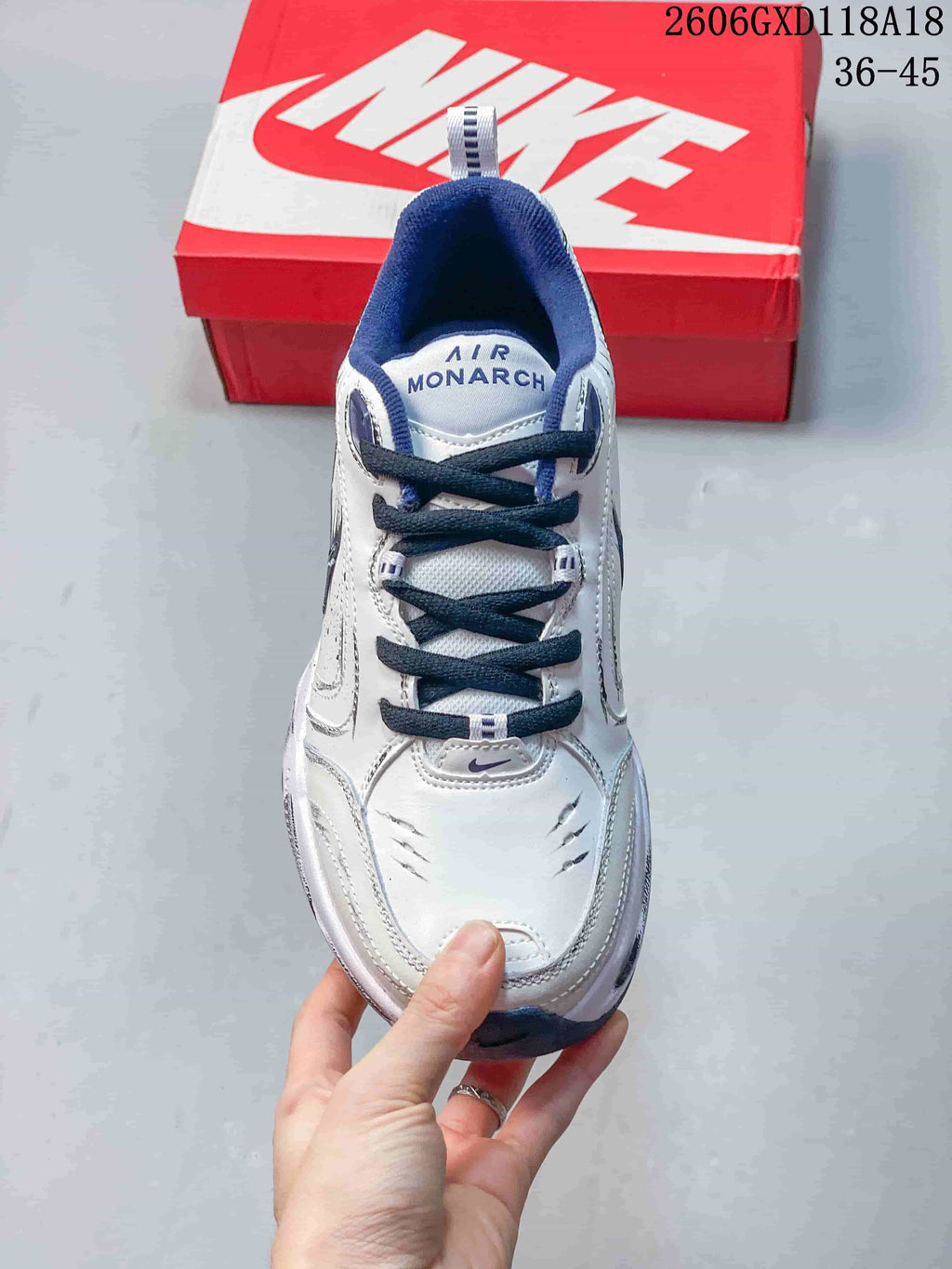 Top view of a Nike Air Monarch sneaker showing dark laces, navy lining and branded tongue.