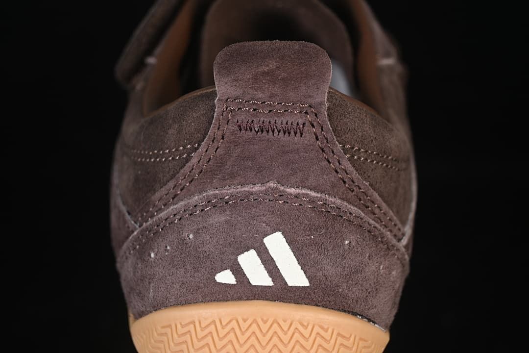 Rear view of the sneaker with a heel pull tab, logo, and gum outsole.