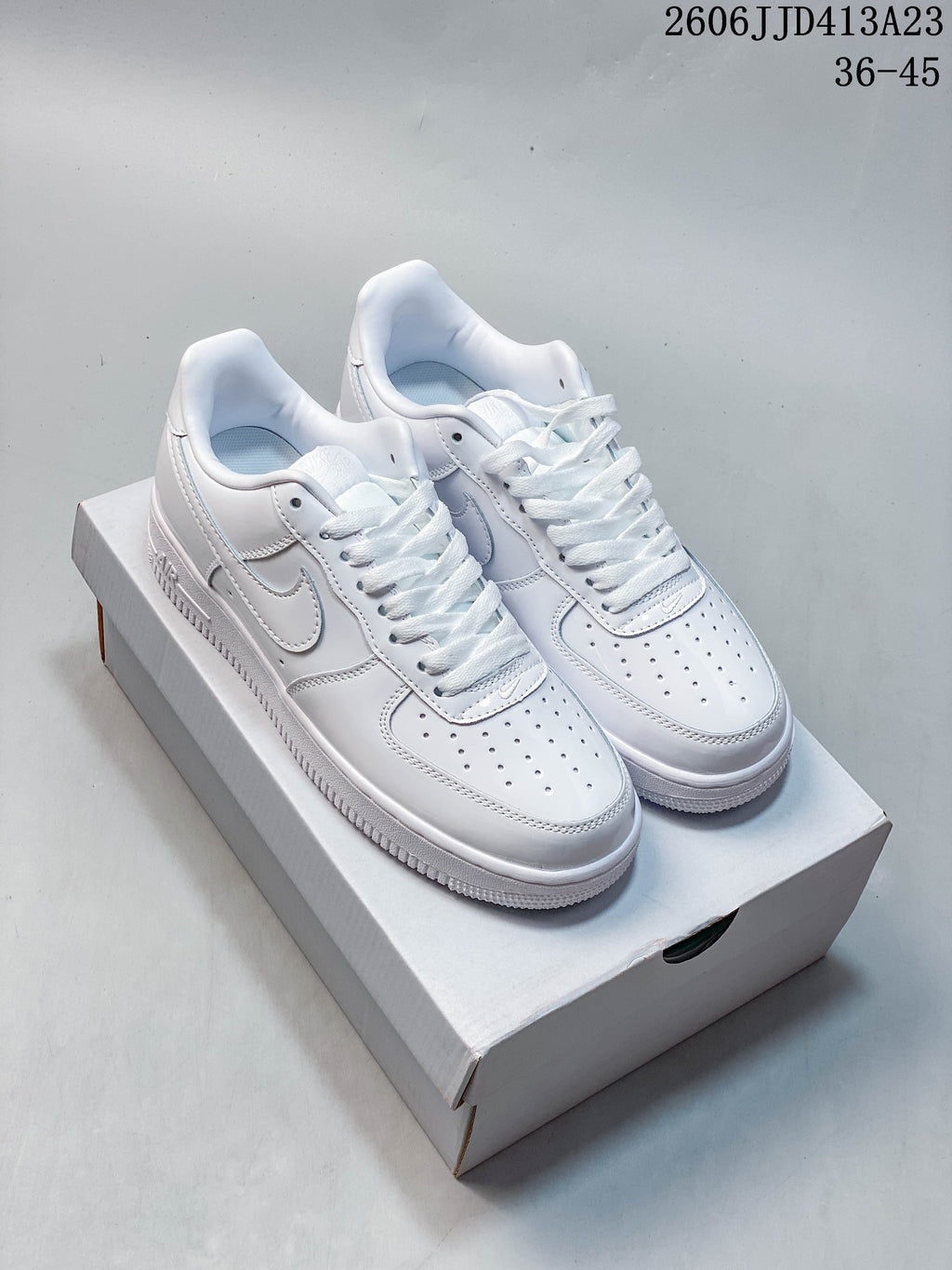 Pair of white Nike Air Force 1 '07 Low sneakers shown from the front and side