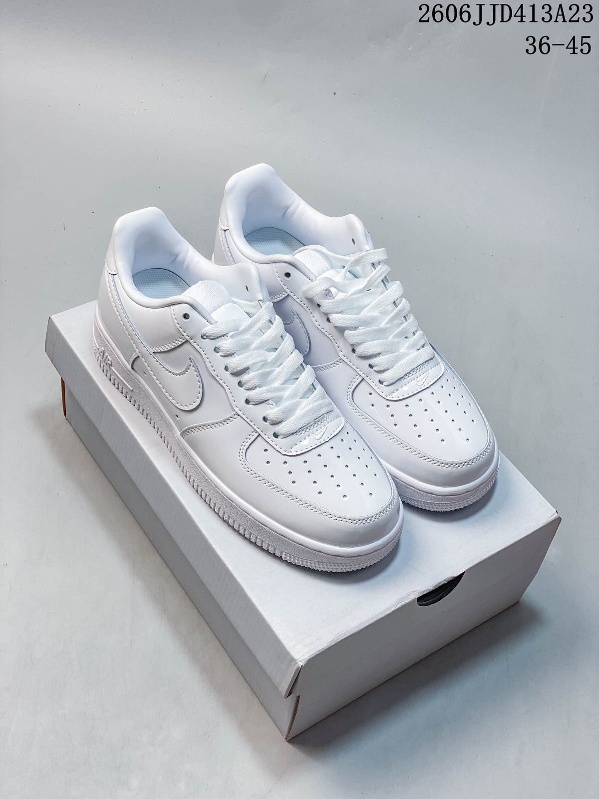 Pair of white Nike Air Force 1 '07 Low sneakers shown from the front and side