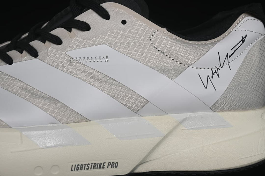 Close-up of the patterned upper, side stripes and Lightstrike Pro sole lettering