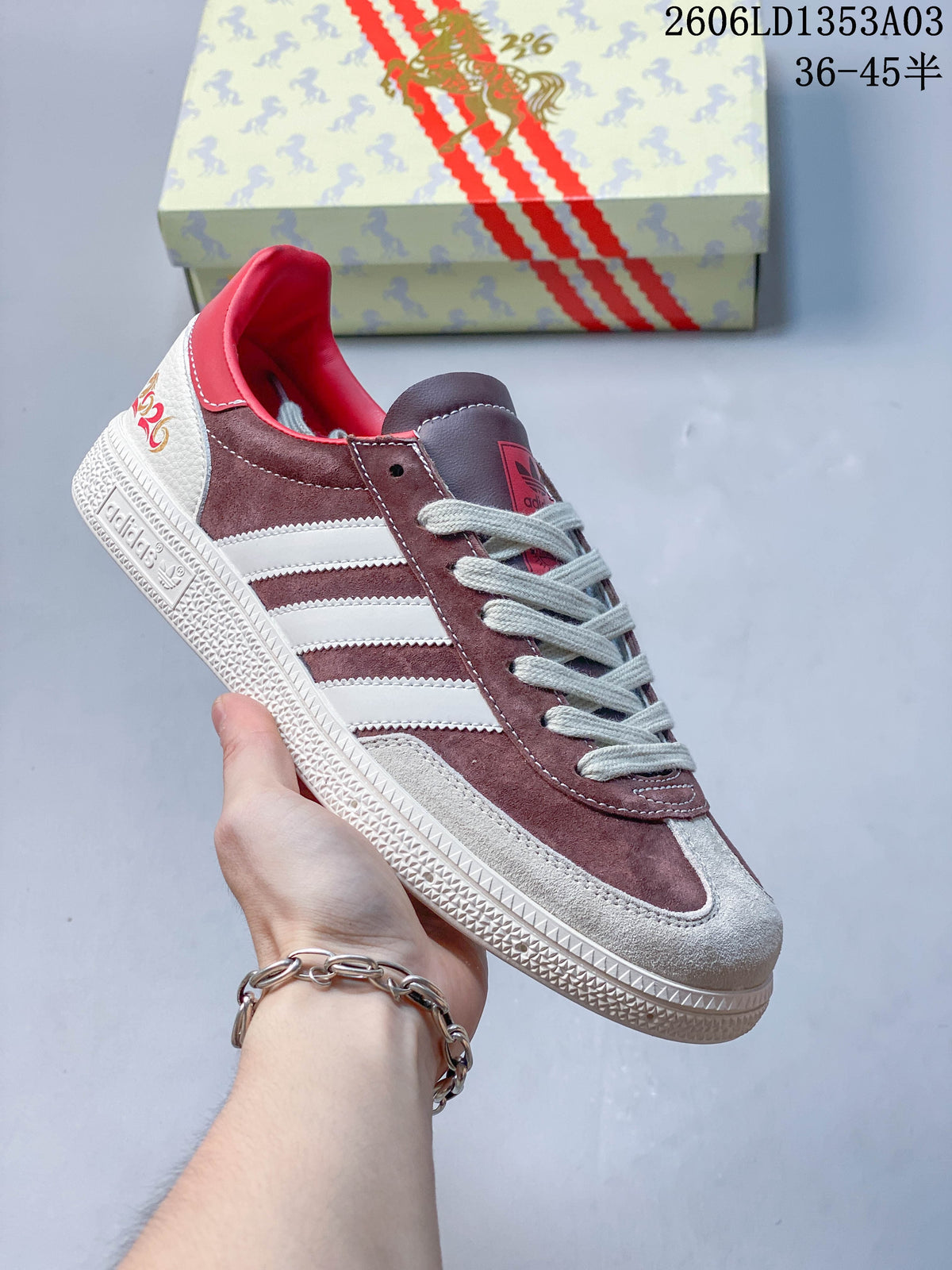 Burgundy and white Gazelle Indoor sneaker with light laces and a horse-themed box.