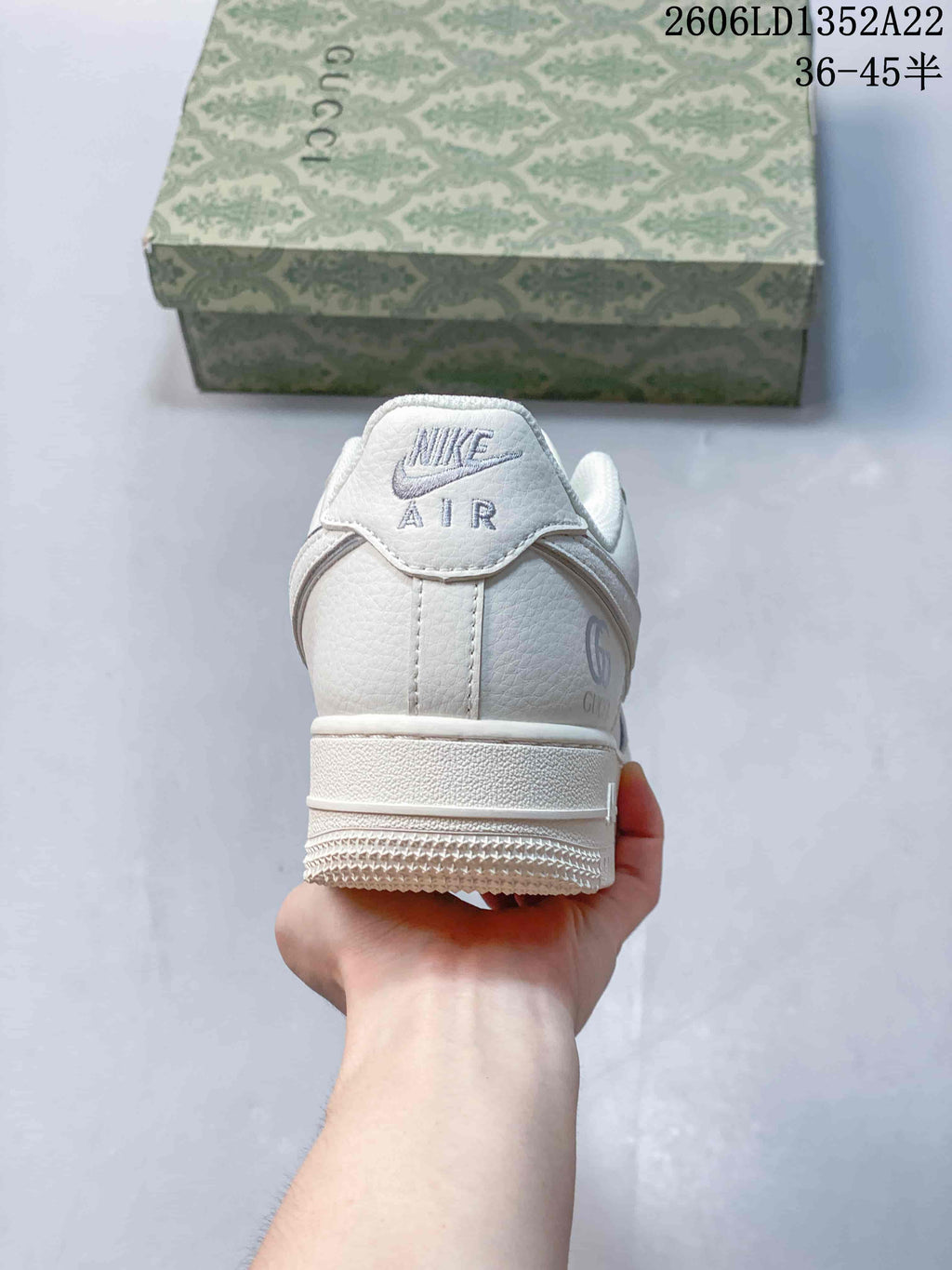 Rear view of the white sneaker showing Nike Air branding and heel details.