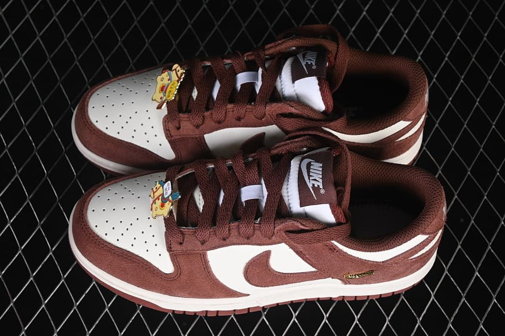 Pair of brown and white low-top sneakers viewed from above