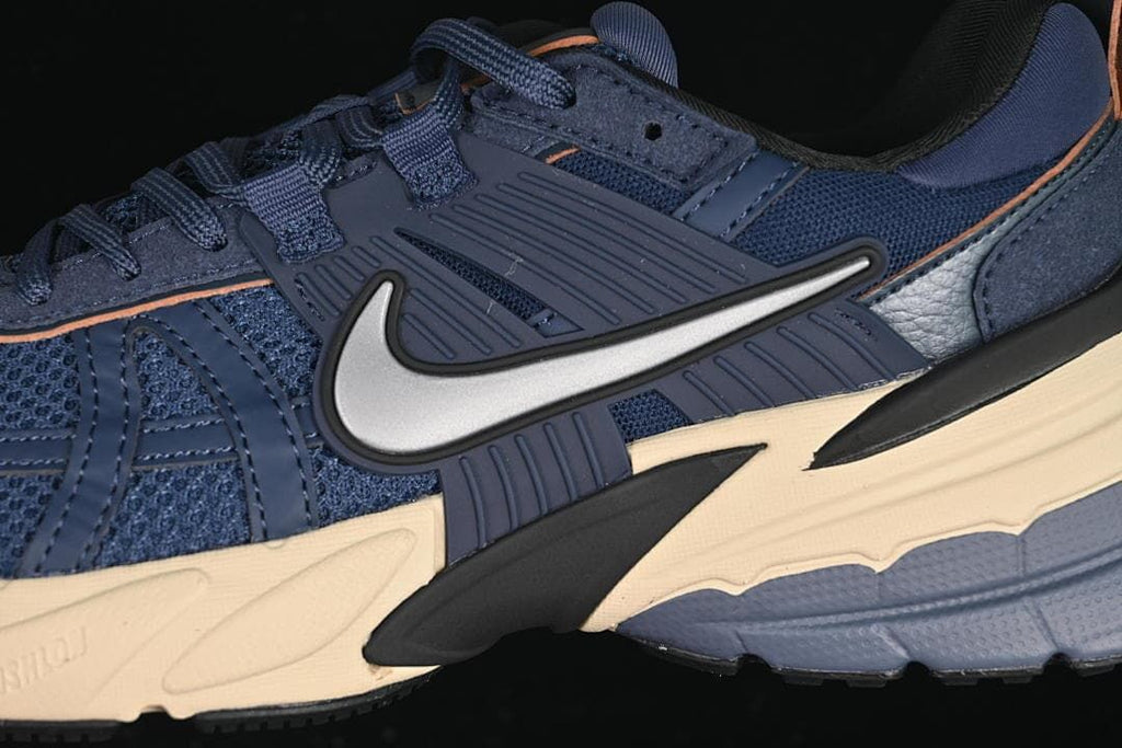 Close-up of the sneaker's side panels, laces, and light-colored Swoosh