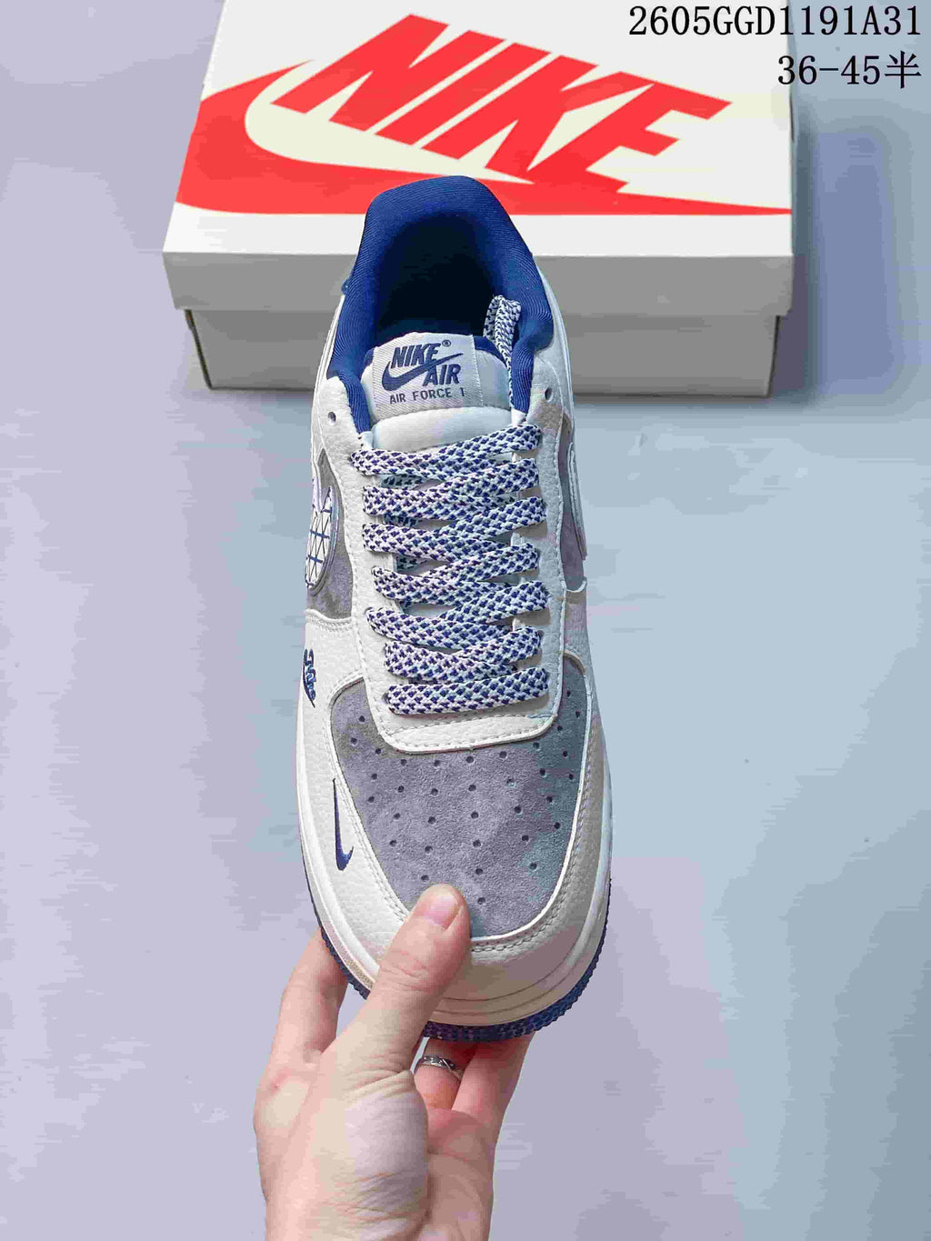 Top view showing the perforated grey toe, patterned laces and blue collar lining.