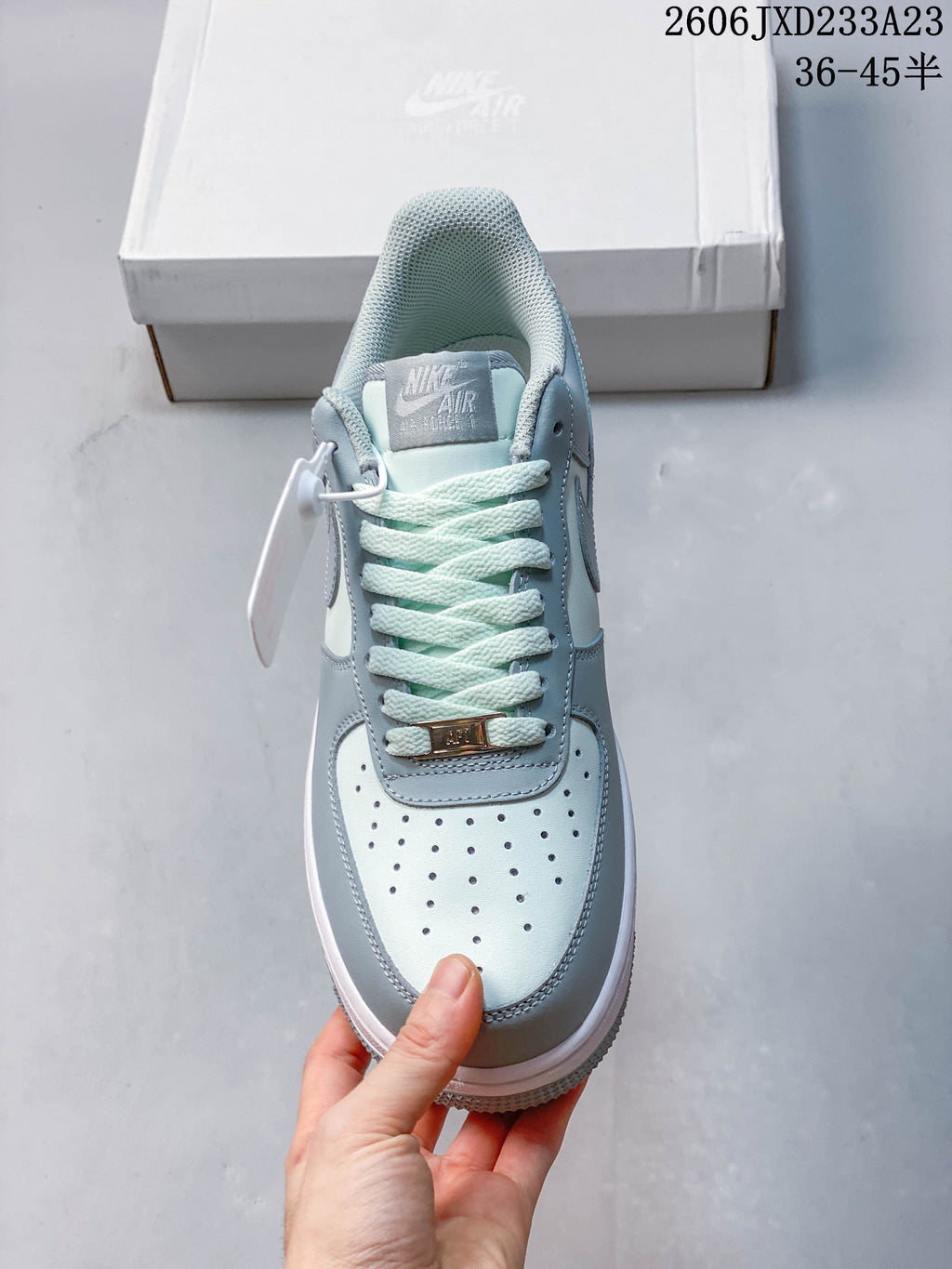 Top view highlighting the perforated toe and laces of a pale blue sneaker
