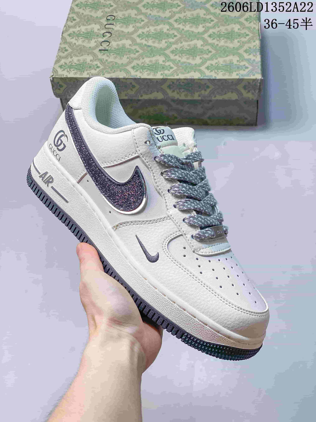 White low-top sneaker with dark glitter-effect Swoosh and contrast branding.