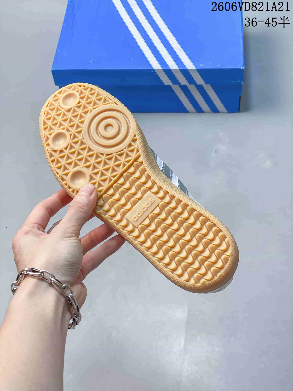 Underside of a sneaker showing a gum-colored outsole with textured tread.