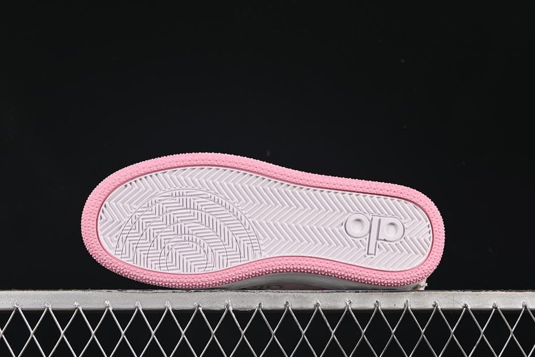 Outsole view showing patterned tread and pink edging