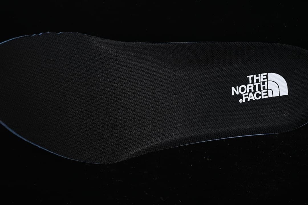 Close-up of a black insole with The North Face logo.