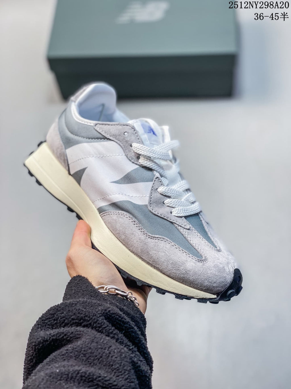New Balance 327-style sneaker in gray and white with blue tongue detail