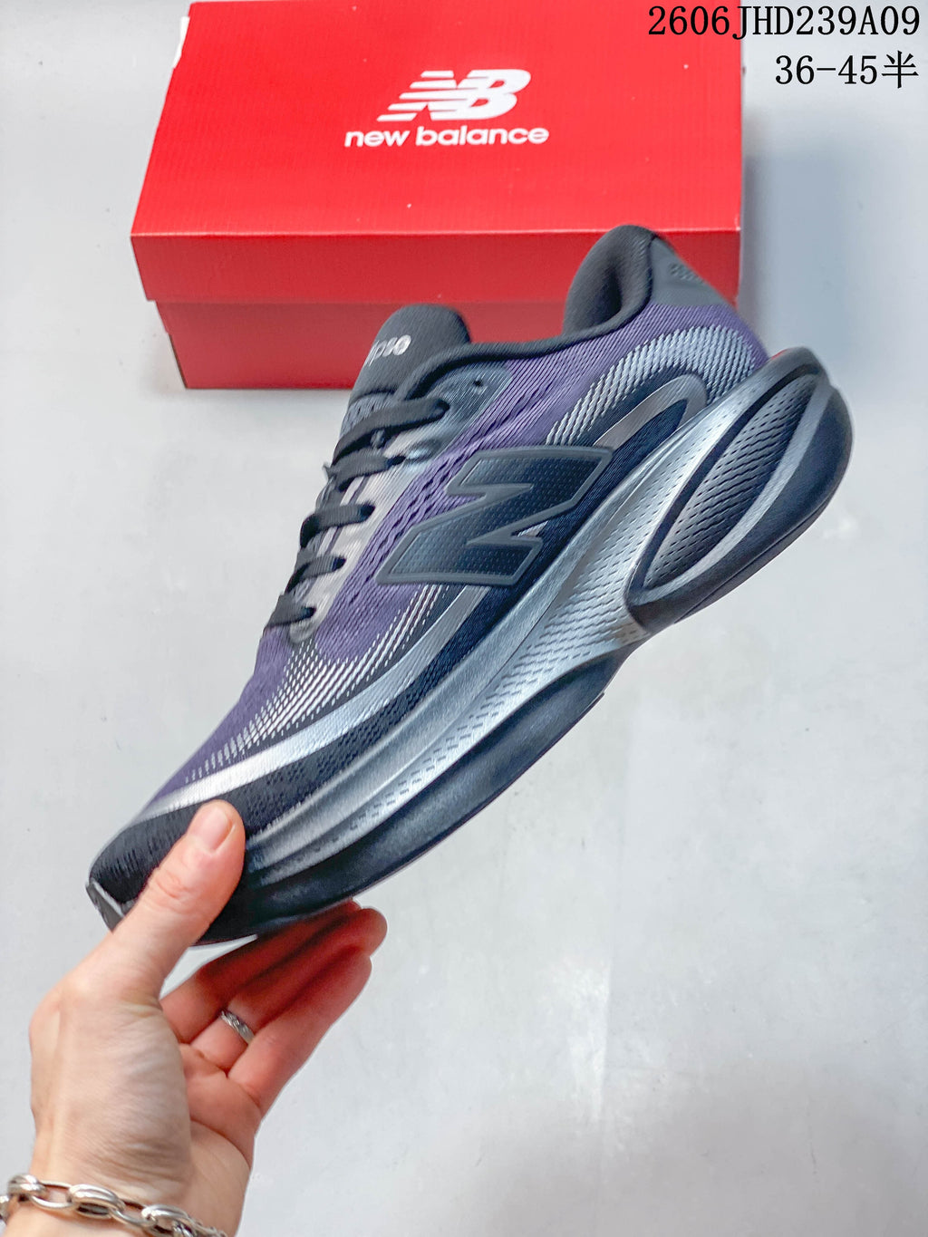 Side view of a purple and gray New Balance Ellipse shoe