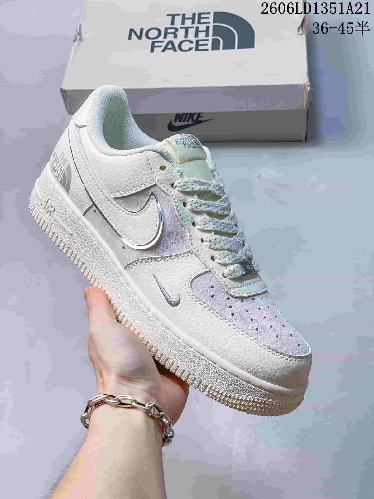 White low-top sneaker with a pale iridescent Swoosh and subtle lavender accents