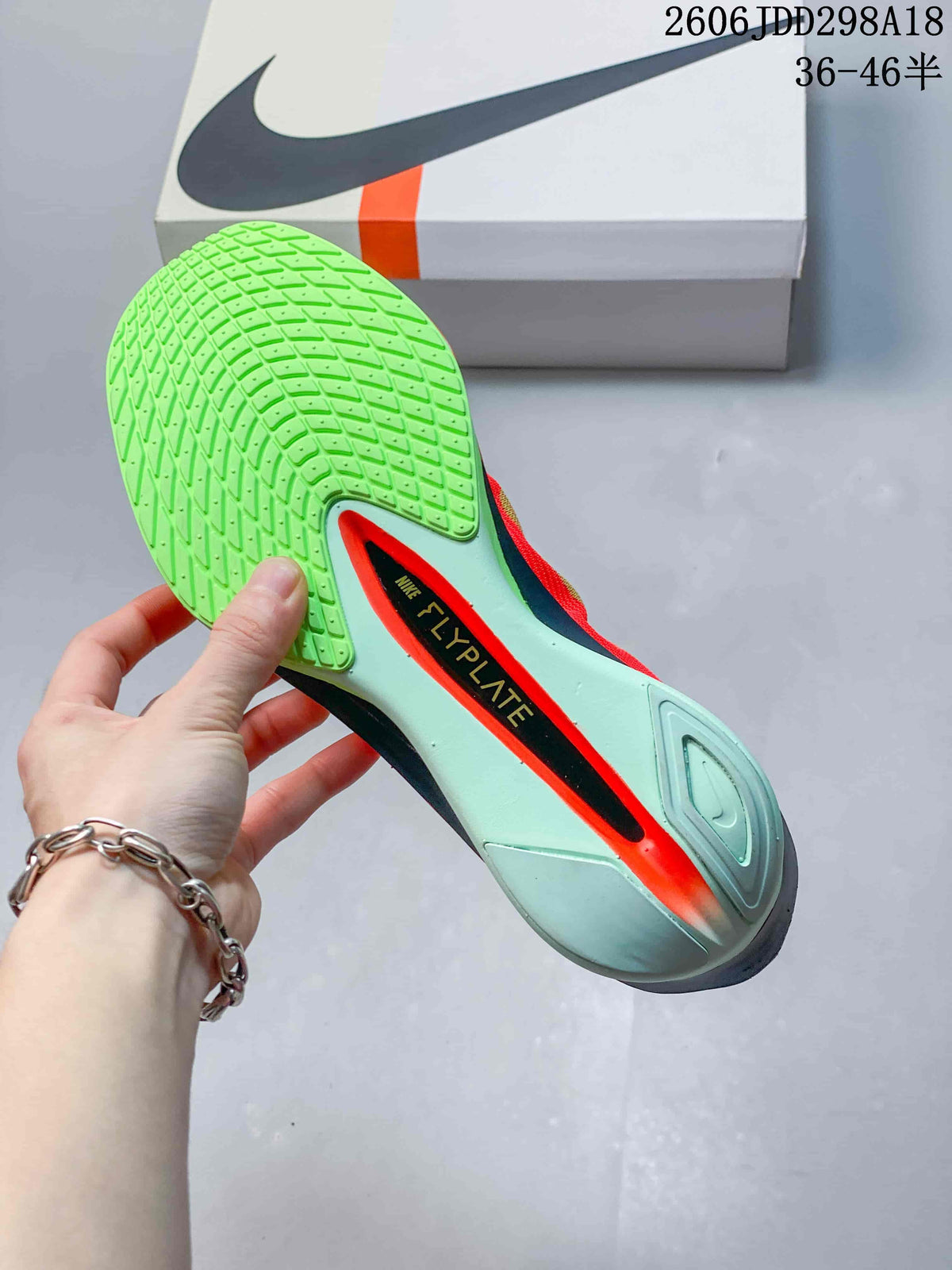 Close-up of the bright green patterned outsole and central plate area