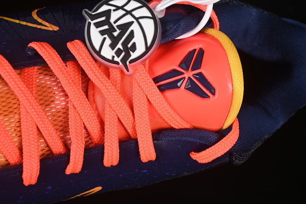 Close-up of the tongue logo and coral laces.