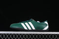 Side view of a dark green adidas Tokyo sneaker with white stripes and a black sole.