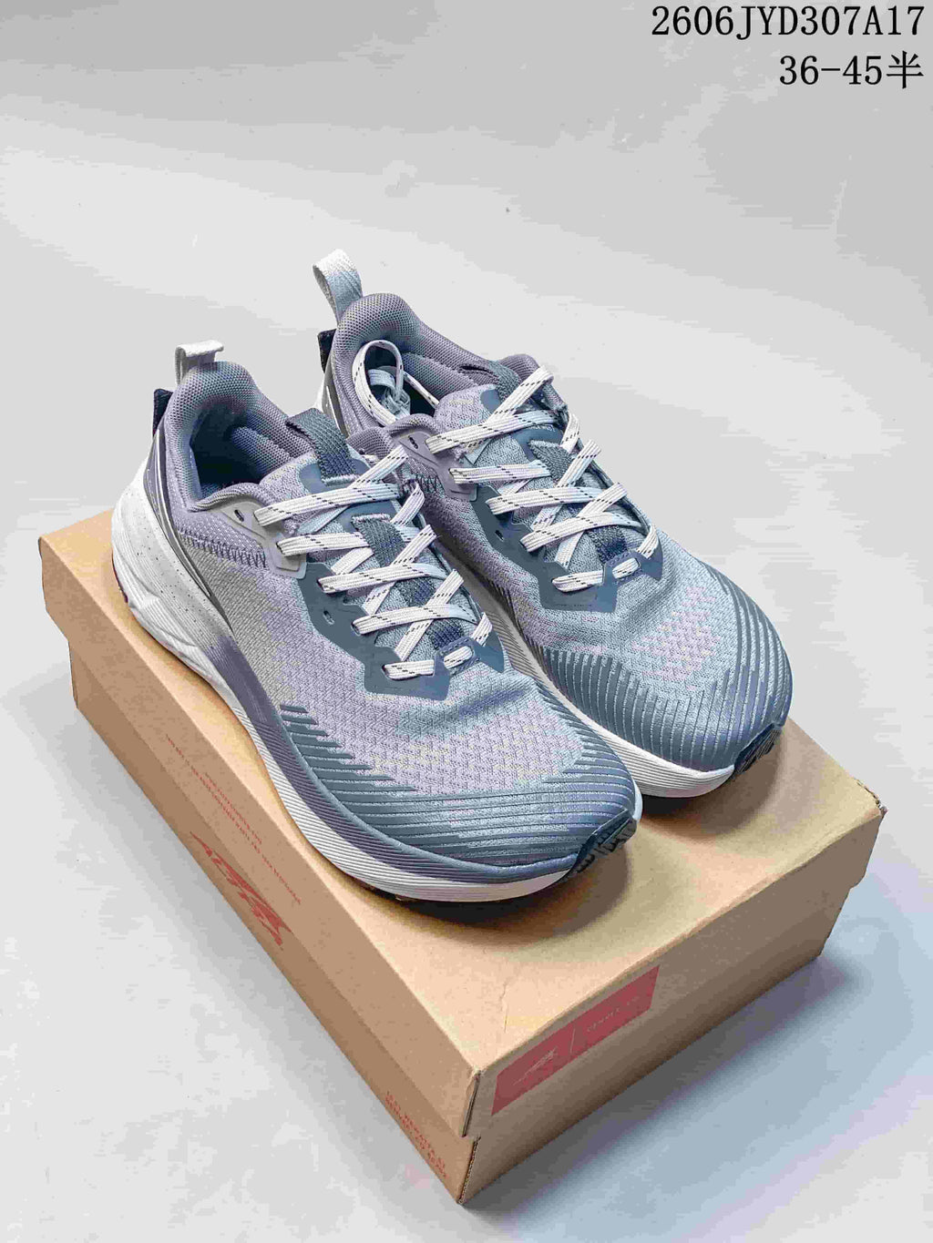 Pair of gray Altra Experience Wild 2 running shoes viewed from above on a shoe box