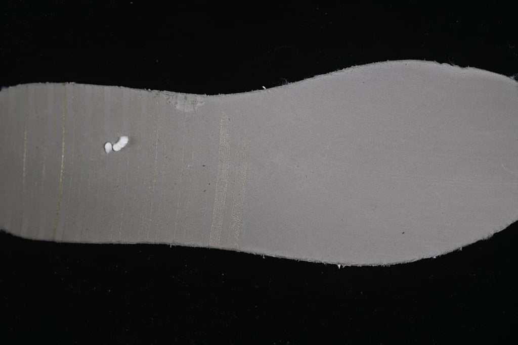 View of the gray underside of the shoe's insole
