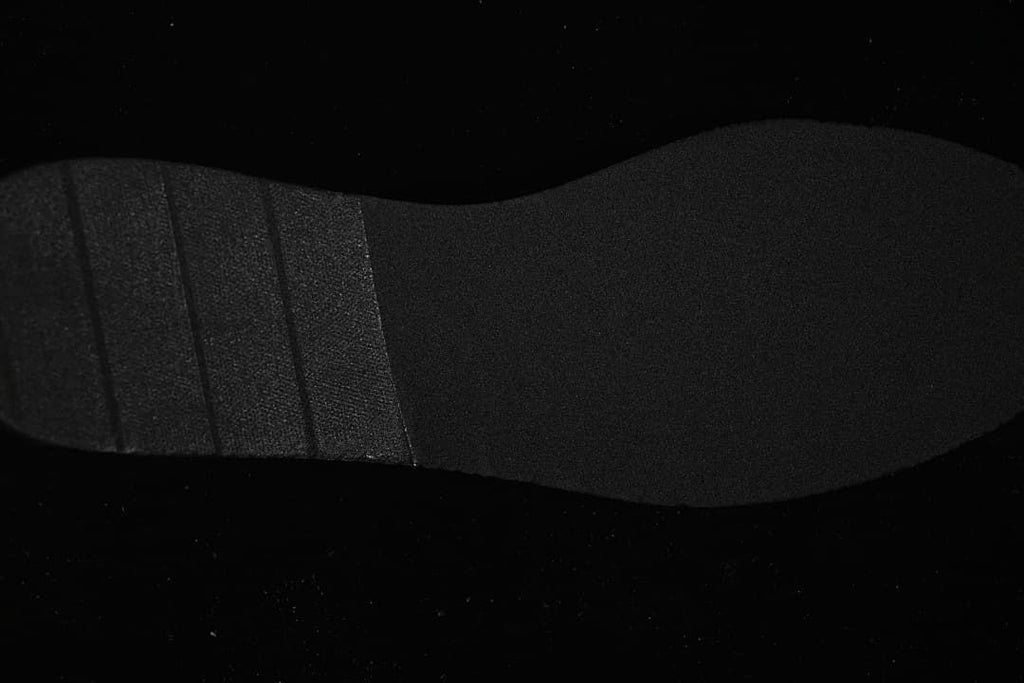 Underside view of the black sneaker outsole