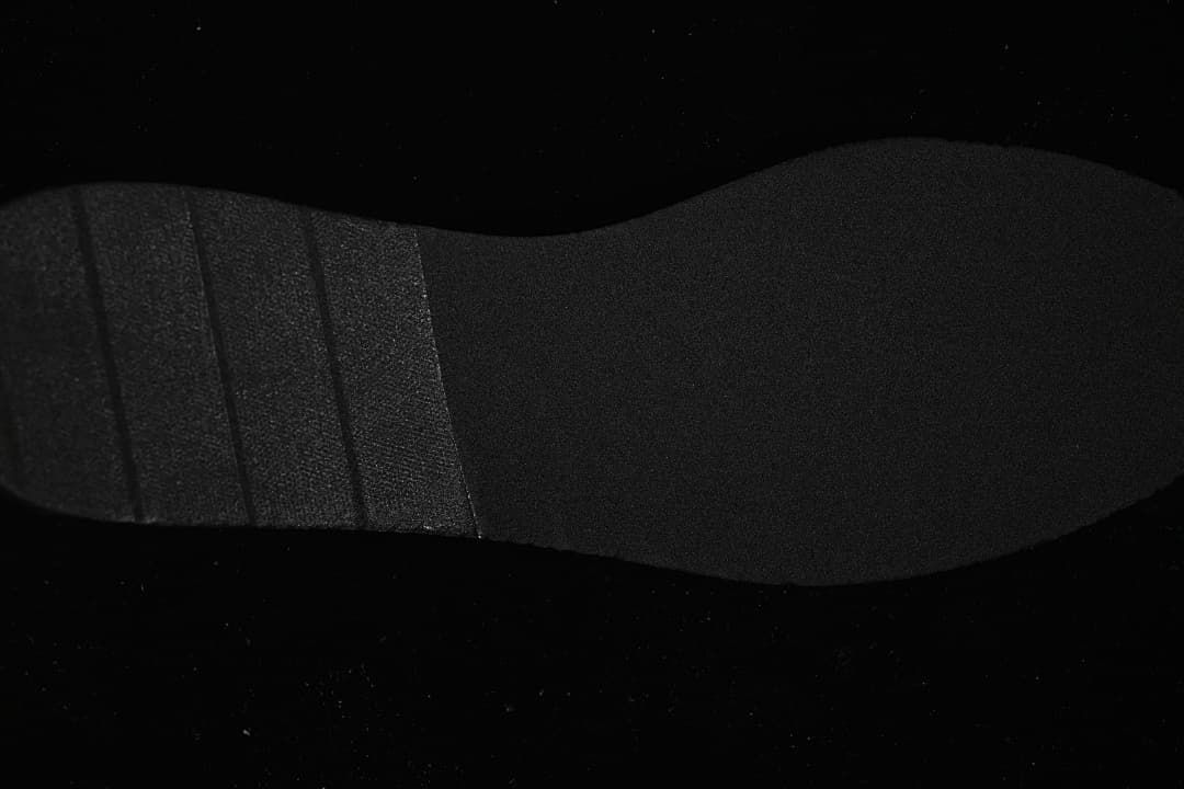 Underside view of the black sneaker outsole
