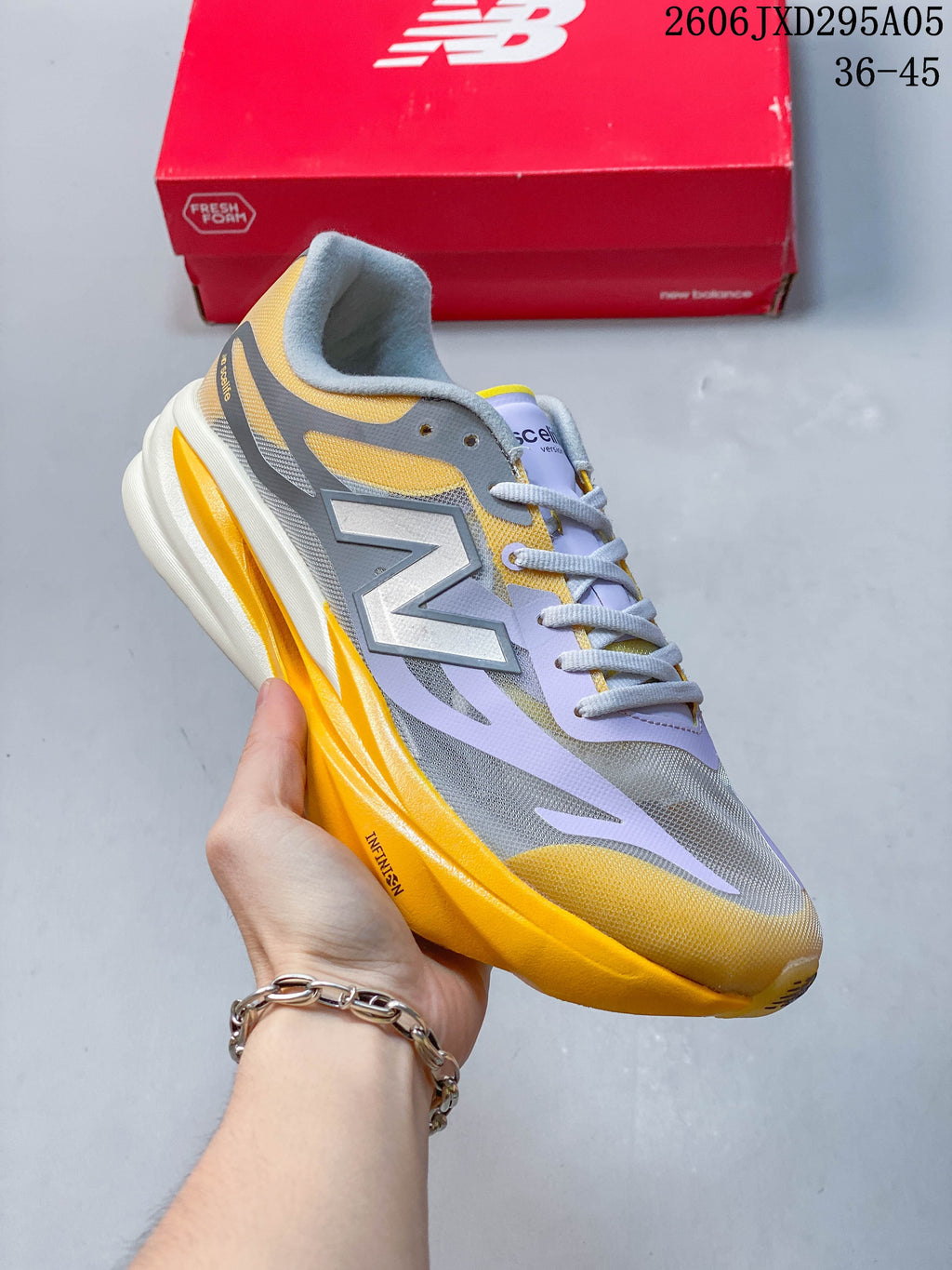 Muted pink-purple New Balance low-top running shoe with matching laces.