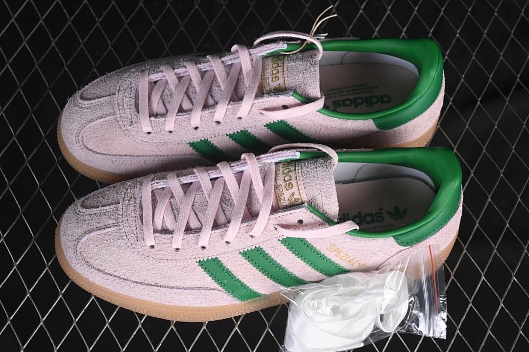 Pair of pink and green sneakers with an extra set of laces