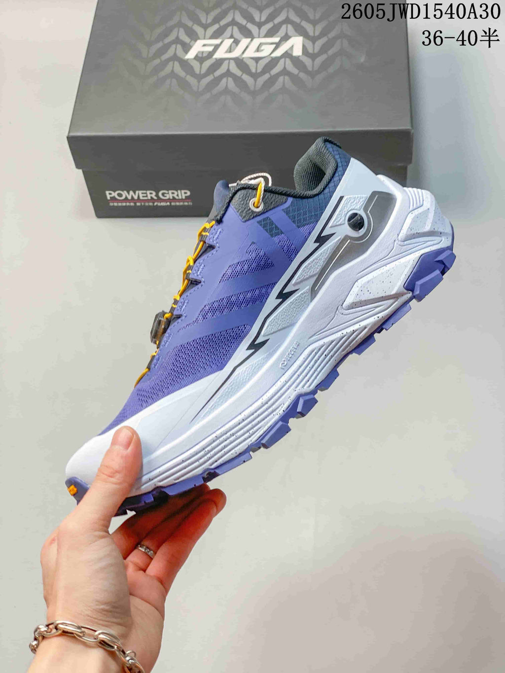 Side view of the purple and white trail shoe with yellow dial-lacing cord