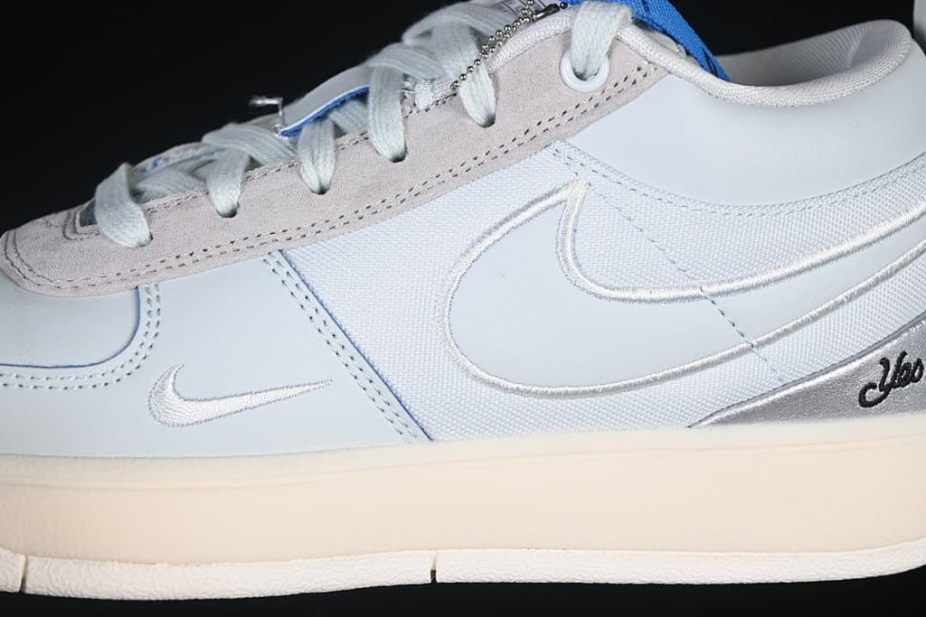 Close-up of the shoe’s side panels, Swoosh details, and cream-colored sole