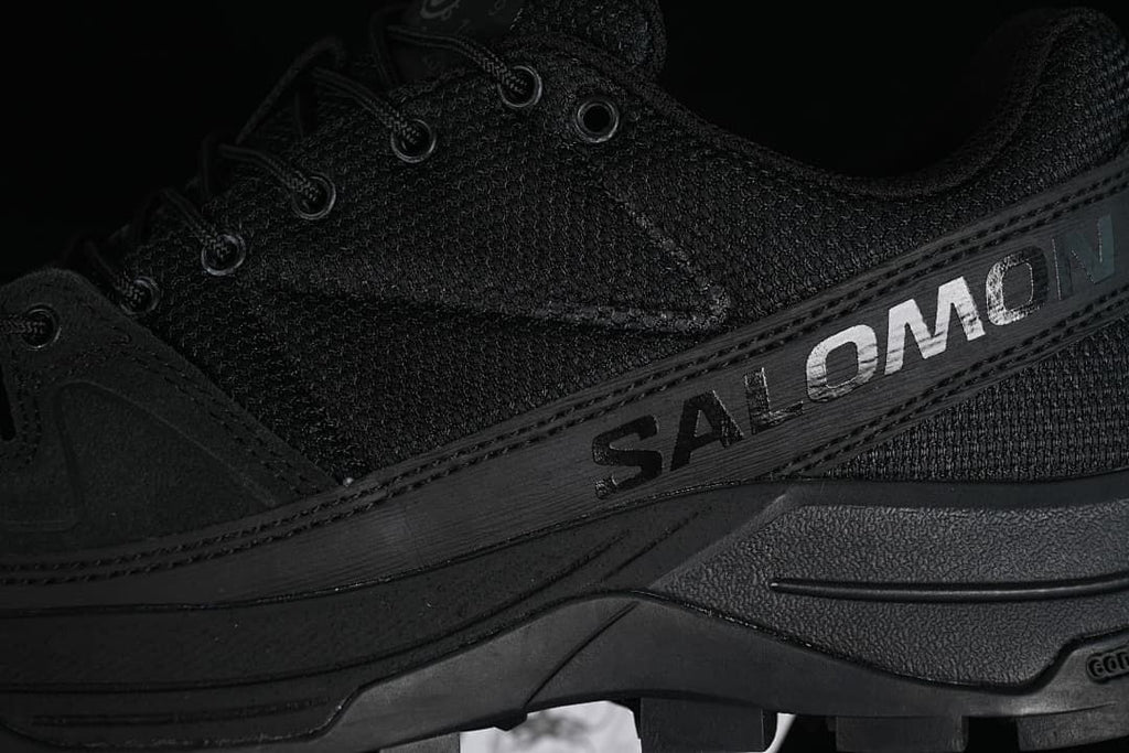 Close-up of Salomon branding on the black side panel