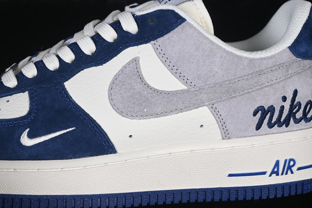 Close-up of the side panels, gray Swoosh, navy overlays, and Air-marked midsole.