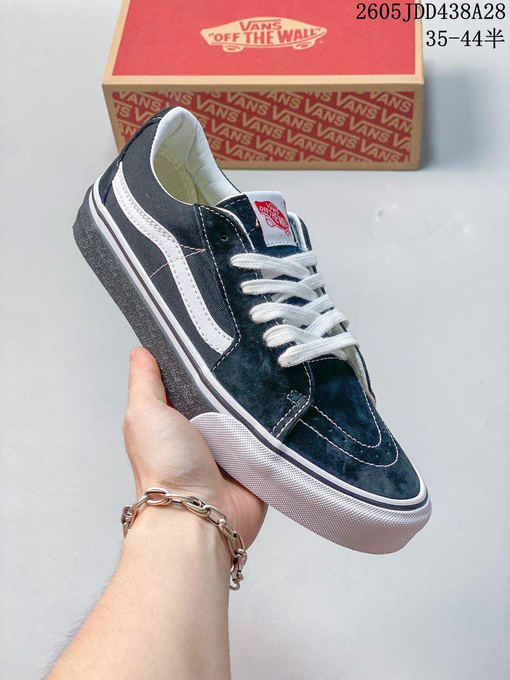 Angled view of a dark green Vans Old Skool sneaker with a white side stripe.