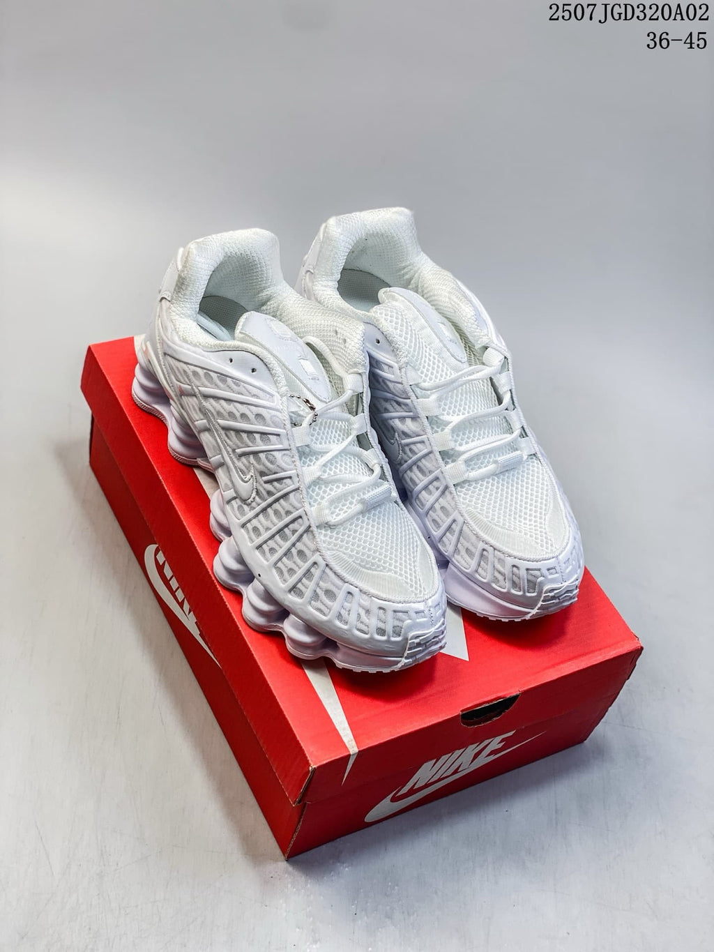 White Nike Shox TL sneakers shown on a red shoe box