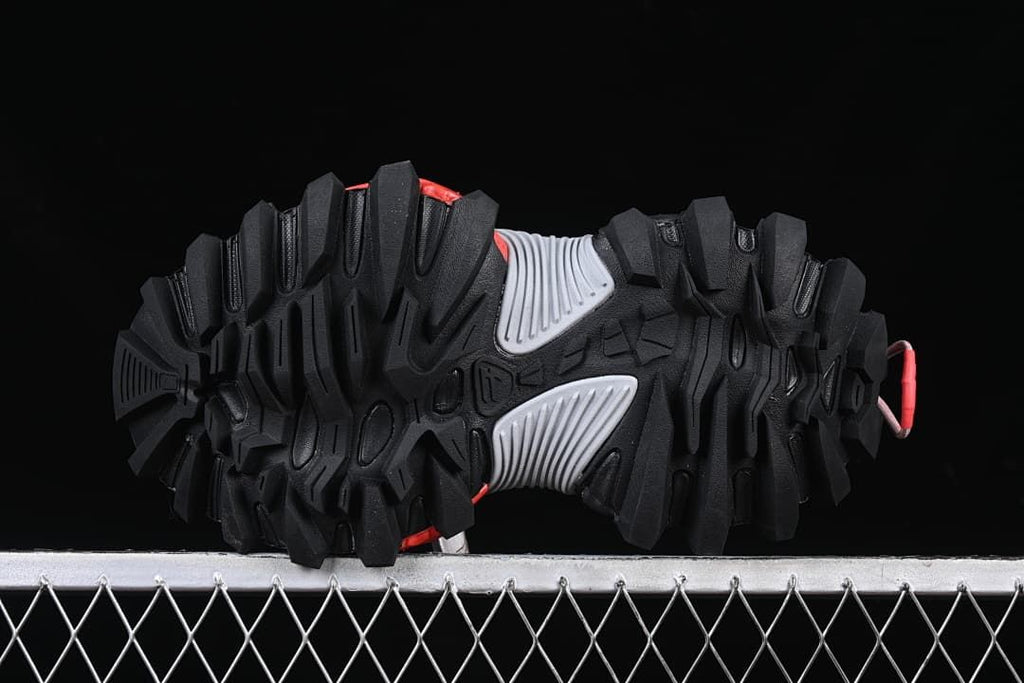 Underside view of the deeply lugged outsole and gray midfoot sections