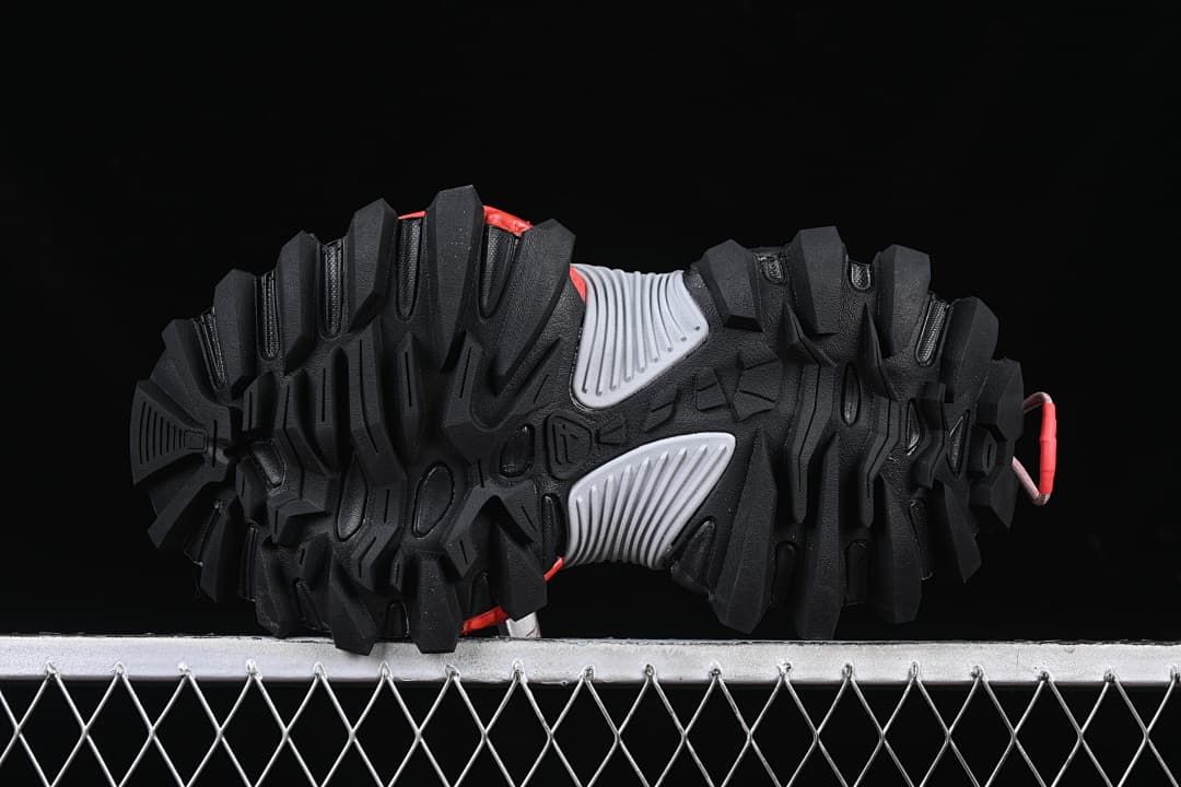 Underside view of the deeply lugged outsole and gray midfoot sections