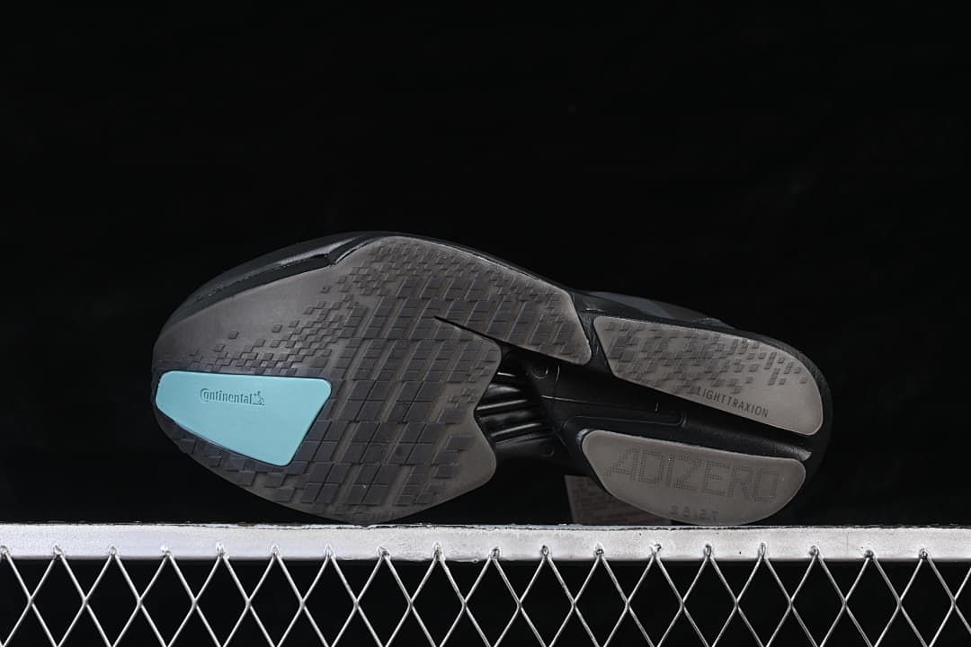 Underside showing the patterned outsole and turquoise traction insert